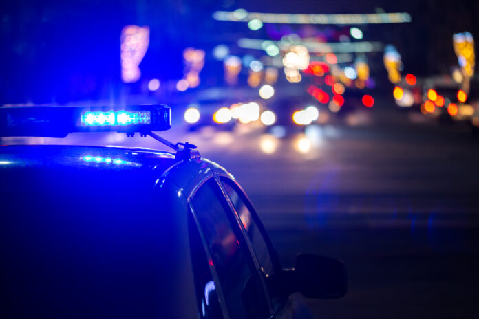 police car lights at night in city with selective focus and bokeh.