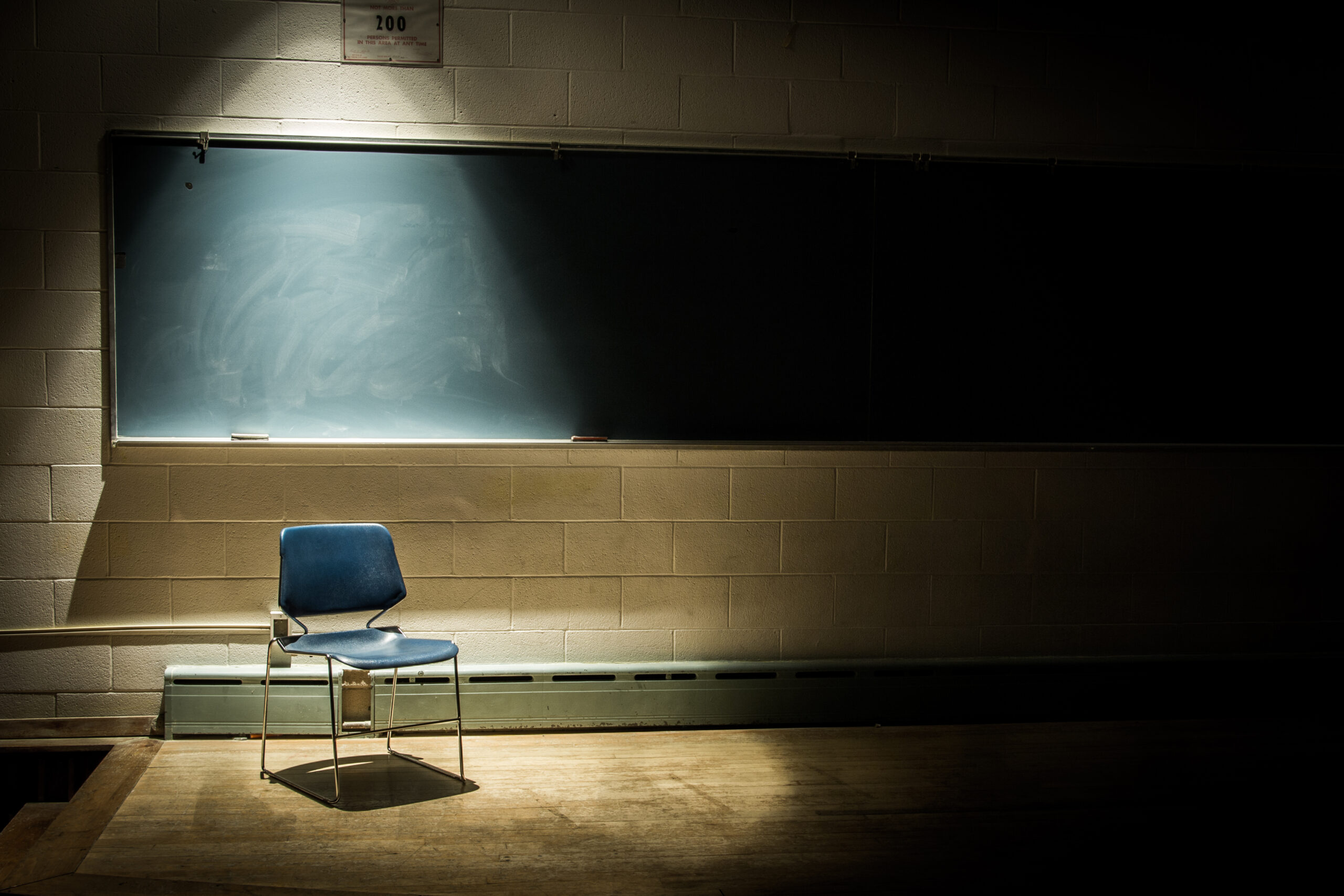 Empty schoolroom in Kentucky with a spotlight on a lone chair