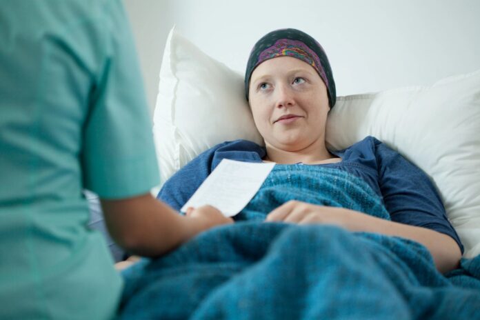 A cancer patient in a hospital bed.