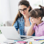 Why Some Parents Choose to Continue Homeschooling after Pandemic Young teacher and cute girl using a laptop together and connecting online, technology and entertainment concept