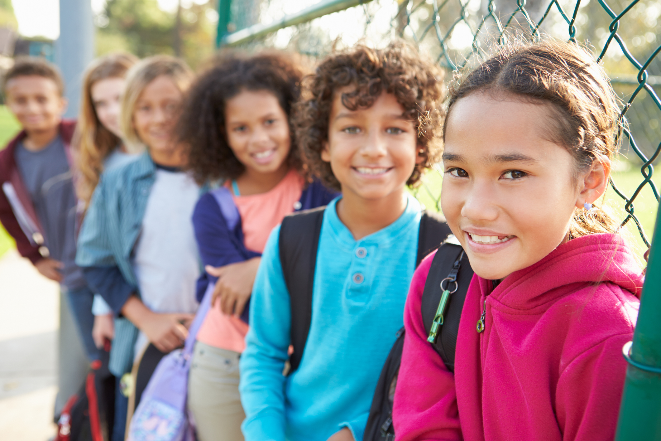 School choice, Group Of Young Children Hanging Out In Playground Smiling To Camera