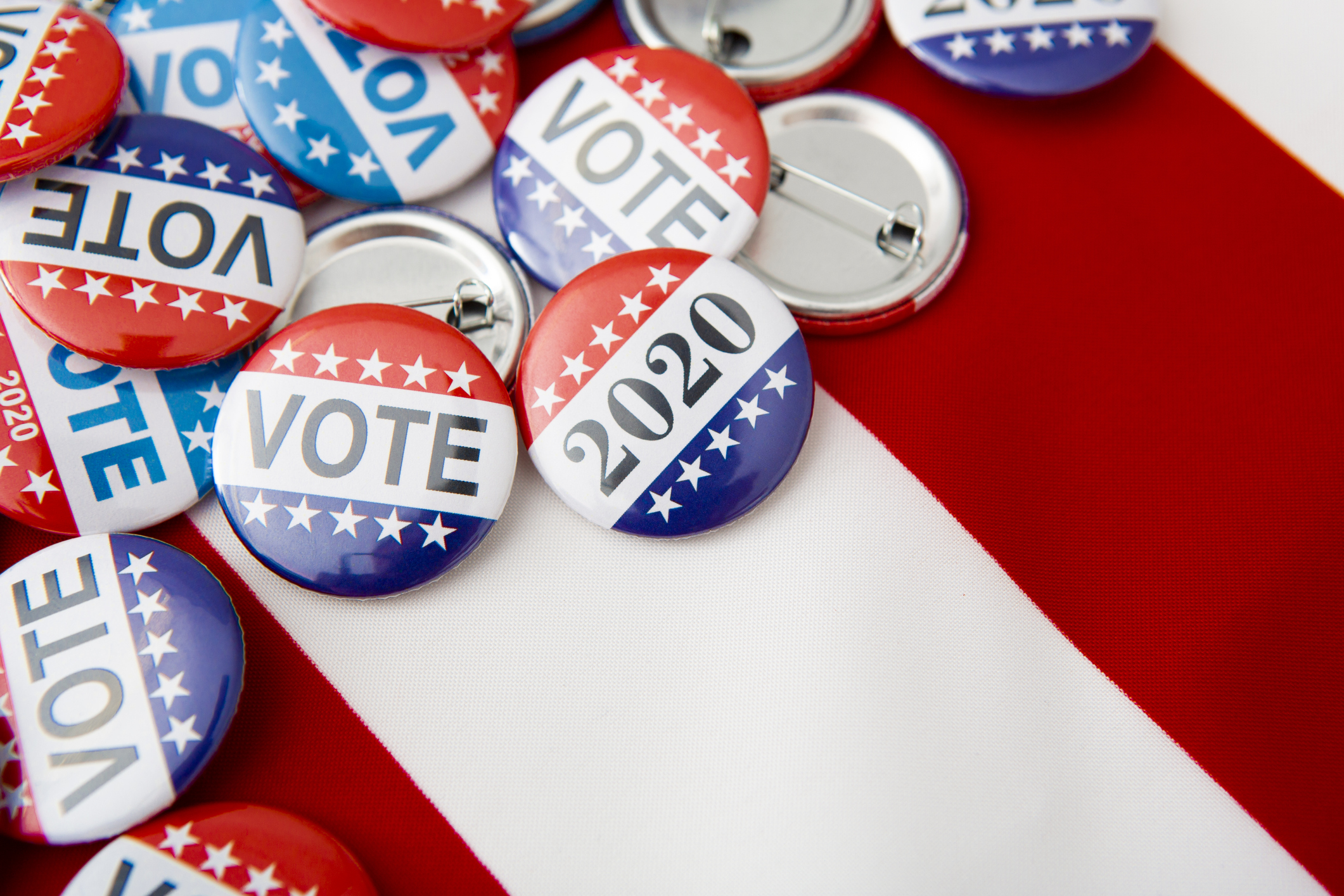 American vote badges on national USA flag background, copy space, elections 2020