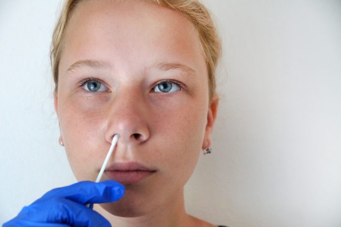 teenage girl undergoing a PCR test for coronavirus, DNA test.