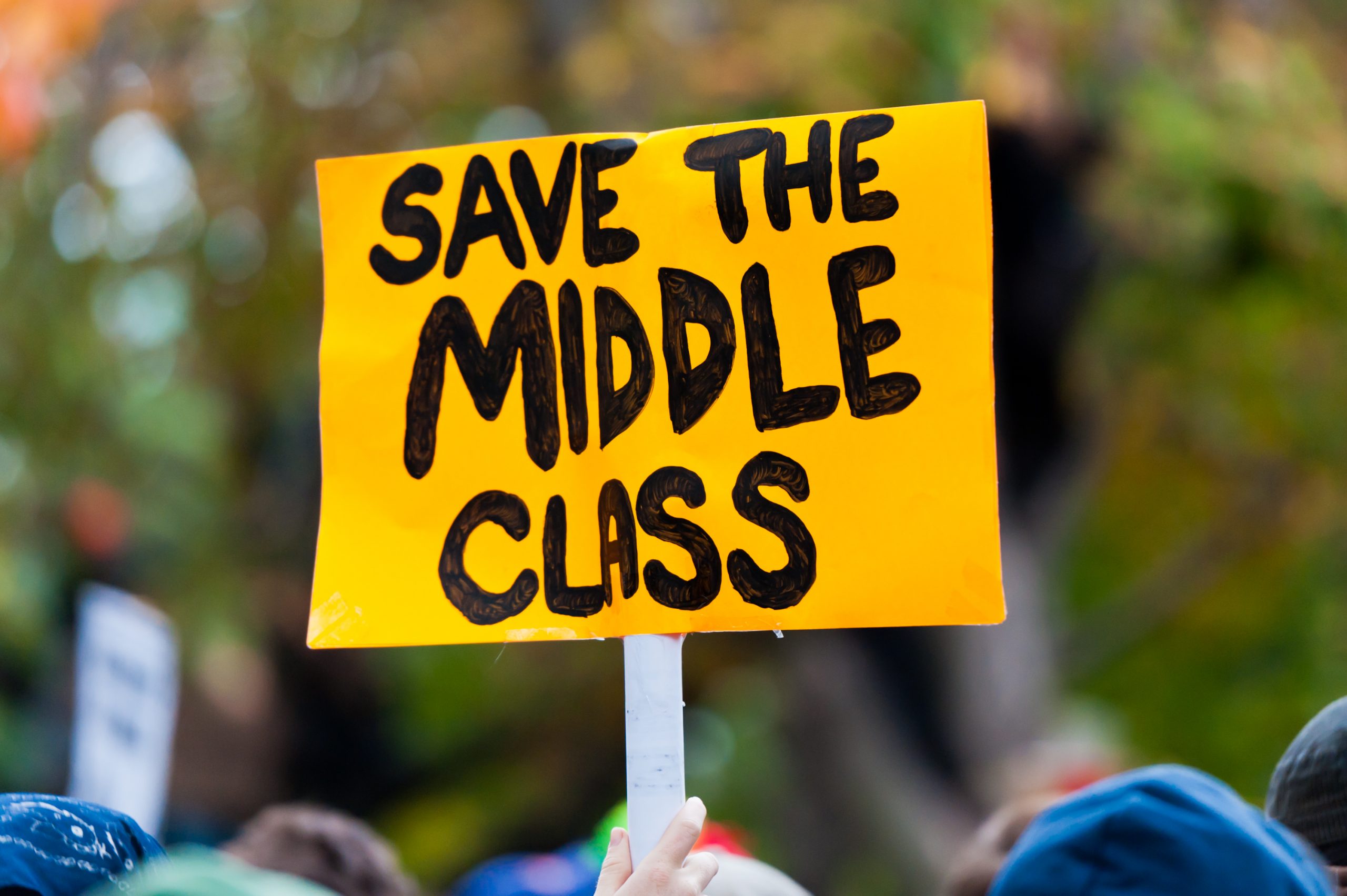 A protest sign reading "Save the Middle Class".