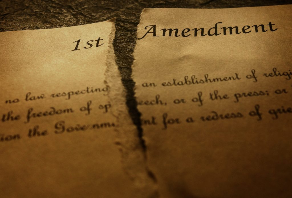 The First Amendment of the US Constitution, torn in half. Civil rights concept