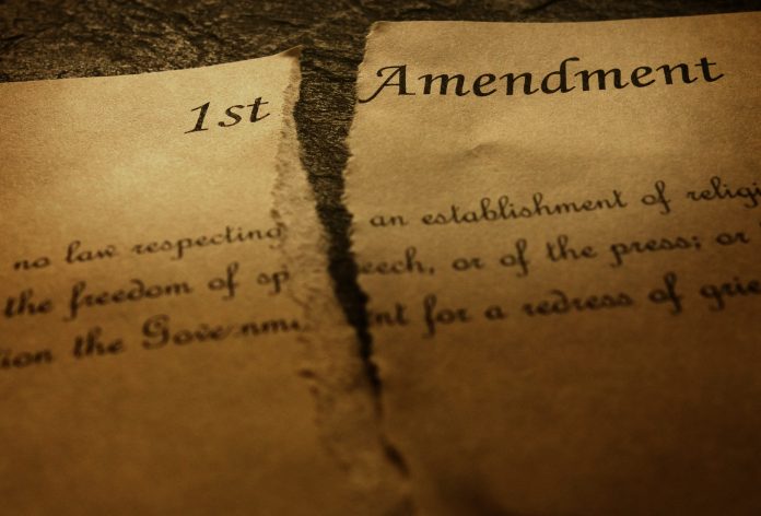 The First Amendment of the US Constitution, torn in half. Civil rights concept