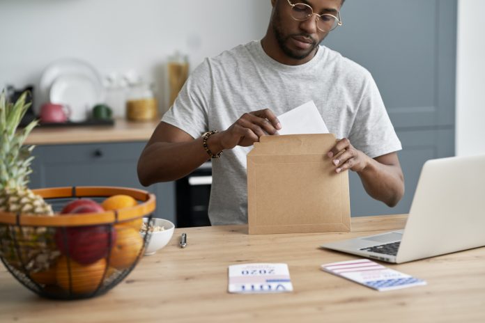 Black man voting from home by mail