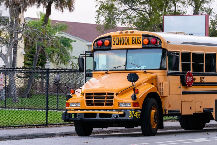 A school bus parked in front of a school