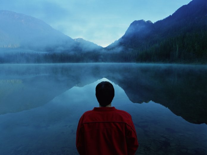 Man standing by lake
