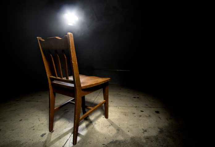 Empty Chair in an Interrogation Room