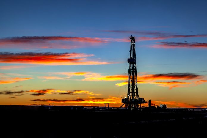 Oil well drilling derrick